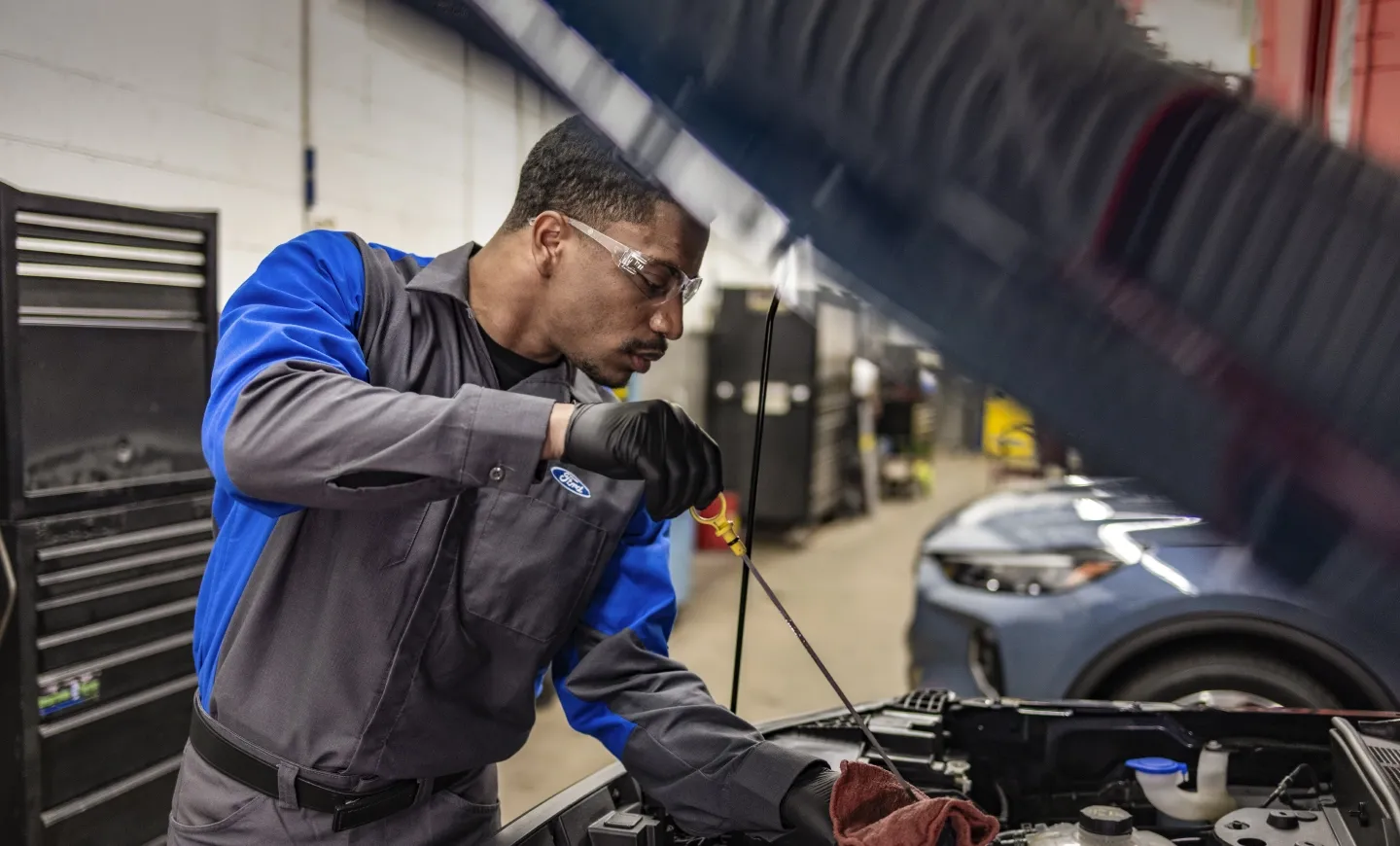 Mechanic checking engine oil level