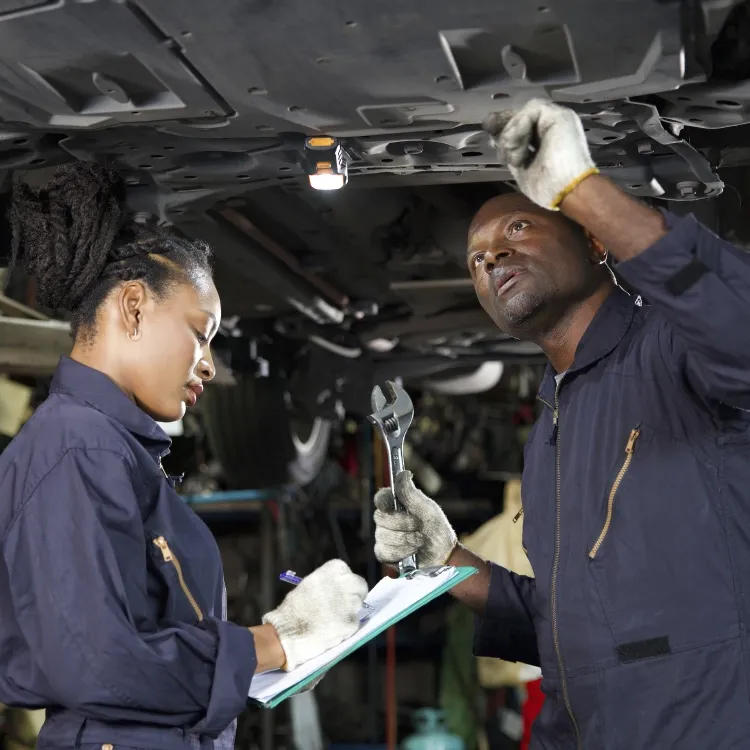 Mechanics checking the underside of the engine